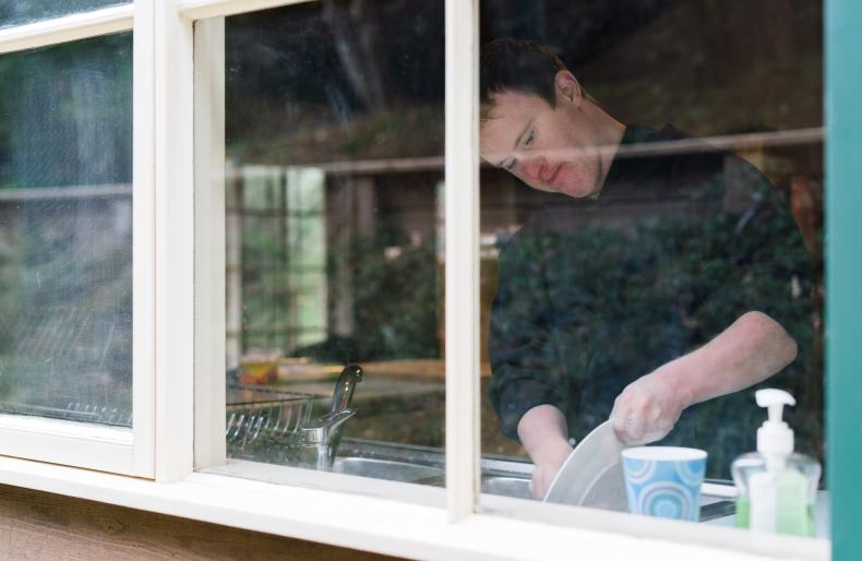 Person with disability washing a plate